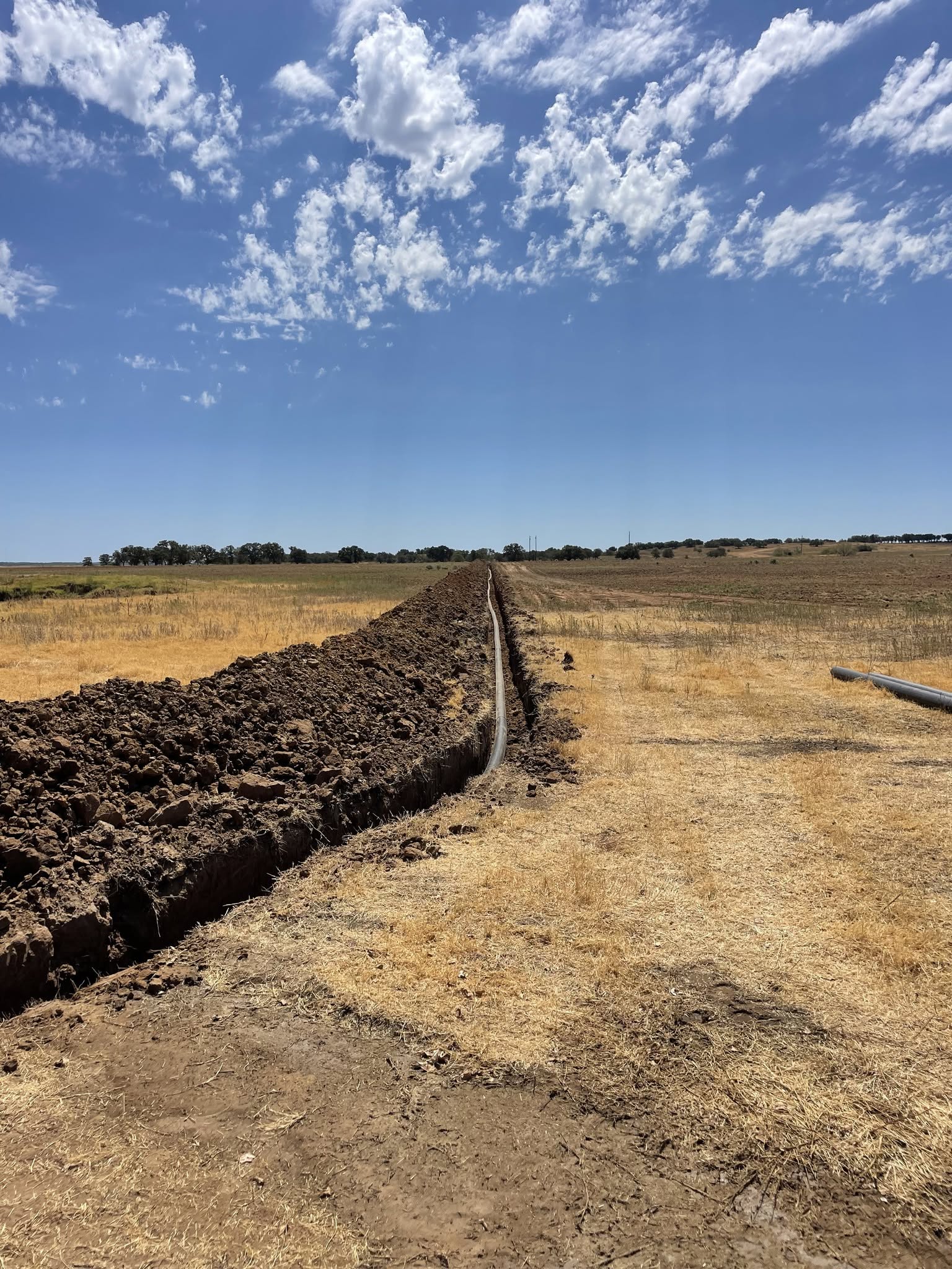 Water and sewer line trenching across a West Texas property
